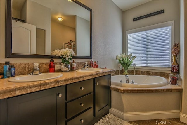 3595 Santa Fe Ave, Long Beach, CA 90810 - full bathroom featuring double vanity, a textured wall, a sink, and a garden tub