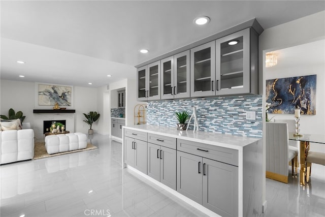 bar with recessed lighting, decorative backsplash, and marble finish floor