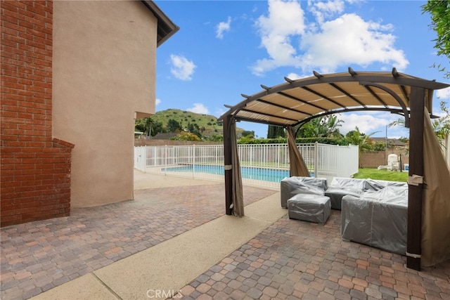 view of patio with a fenced in pool, a mountain view, and a fenced backyard