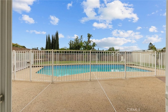 view of swimming pool with a fenced in pool, a fenced backyard, and a patio area