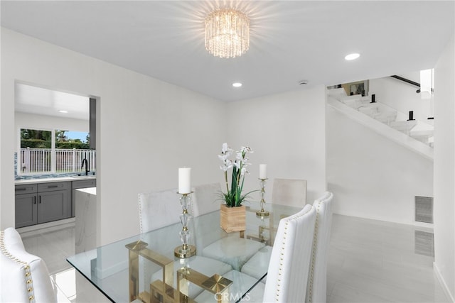 dining area featuring visible vents, recessed lighting, stairs, and a notable chandelier