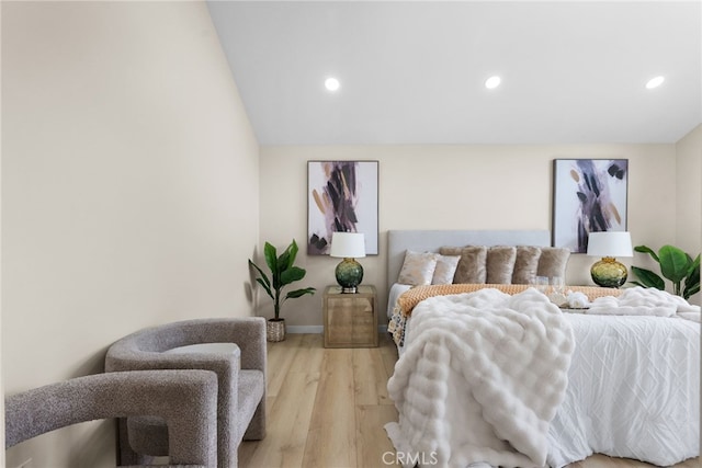 bedroom featuring recessed lighting, baseboards, light wood-type flooring, and lofted ceiling