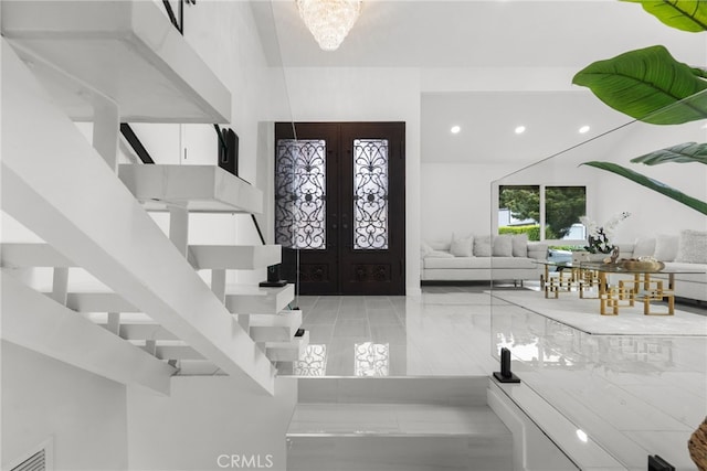 foyer entrance with recessed lighting, visible vents, french doors, and marble finish floor