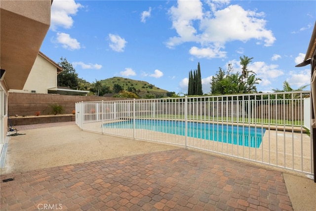 view of swimming pool featuring a patio, a fenced in pool, and a fenced backyard