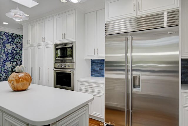 5594 Avenida Sosiega W Unit B, Laguna Woods, CA 92637 - kitchen featuring light countertops, built in appliances, and white cabinets