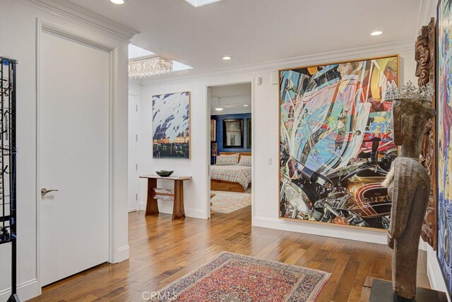 5594 Avenida Sosiega W Unit B, Laguna Woods, CA 92637 - hall with crown molding, recessed lighting, baseboards, and wood finished floors