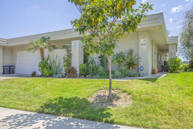 5594 Avenida Sosiega W Unit B, Laguna Woods, CA 92637 - view of home's exterior with an attached garage, stucco siding, a yard, and driveway