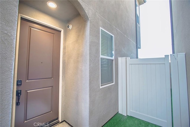 property entrance featuring stucco siding