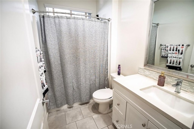 full bath with toilet, tile patterned floors, curtained shower, and vanity