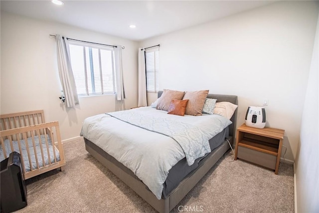 carpeted bedroom featuring baseboards and recessed lighting