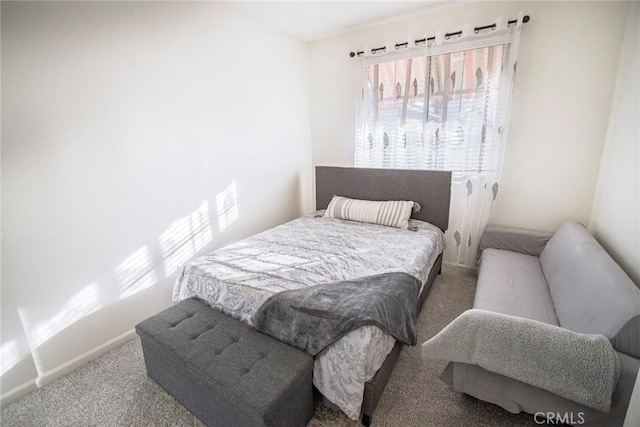 bedroom featuring baseboards and carpet flooring