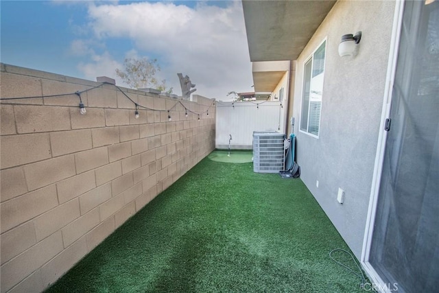 view of yard with fence and cooling unit