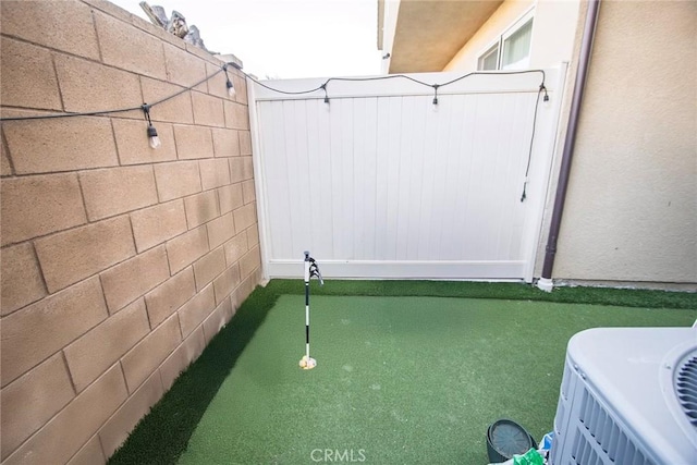 exterior space with central air condition unit and fence