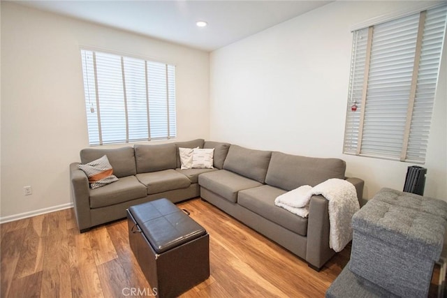 living area featuring recessed lighting, light wood-style flooring, and baseboards