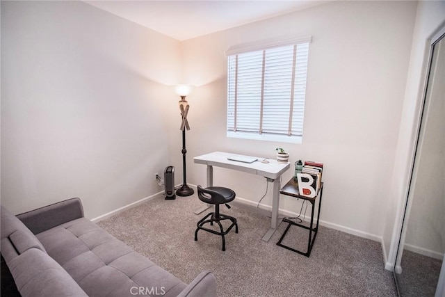 carpeted office featuring baseboards
