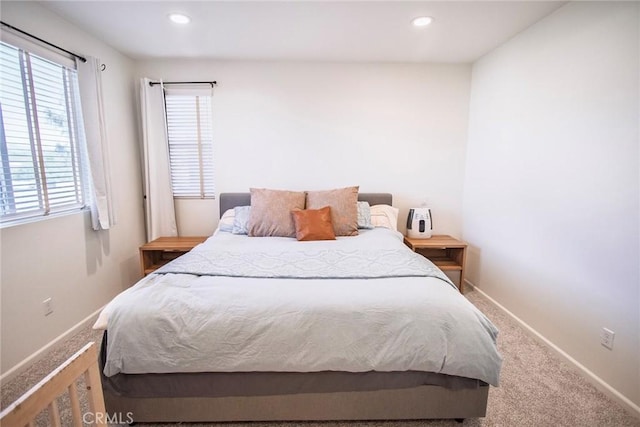 carpeted bedroom featuring baseboards and recessed lighting