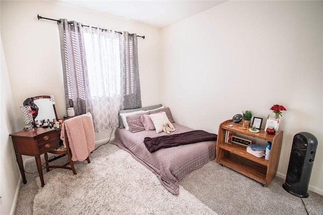 bedroom with carpet floors and baseboards