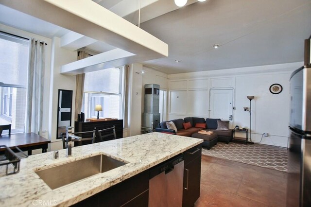 215 W 7th St Unit 803, Los Angeles, CA 90014 - kitchen featuring a sink, appliances with stainless steel finishes, open floor plan, and light stone counters