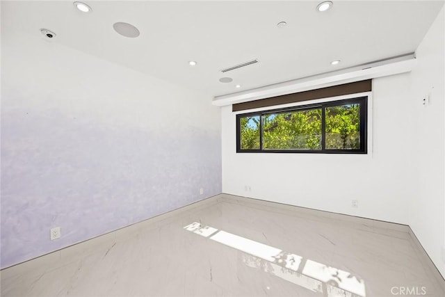 unfurnished room featuring visible vents, recessed lighting, and marble finish floor
