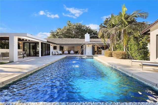 outdoor pool with an outdoor living space and a patio