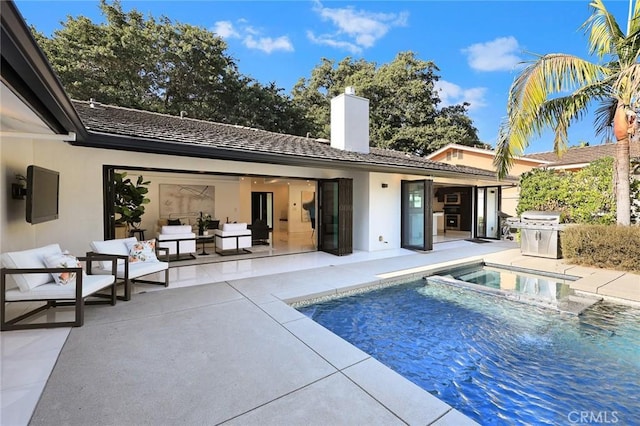 back of property with a patio, stucco siding, an outdoor hangout area, a chimney, and a pool with connected hot tub