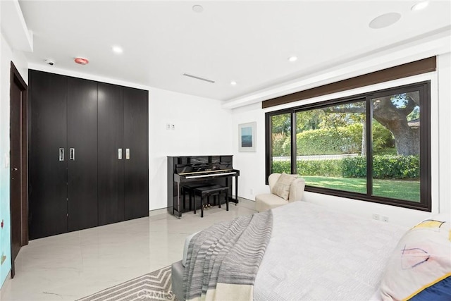 bedroom with recessed lighting and light tile patterned floors