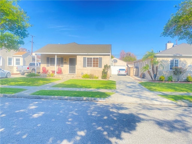 bungalow-style house with a garage, stucco siding, and a front yard
