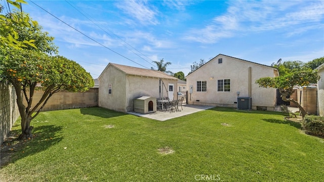 6048 Fidler Ave, Lakewood, CA 90712 - rear view of property with central air condition unit, stucco siding, an outbuilding, and a patio area