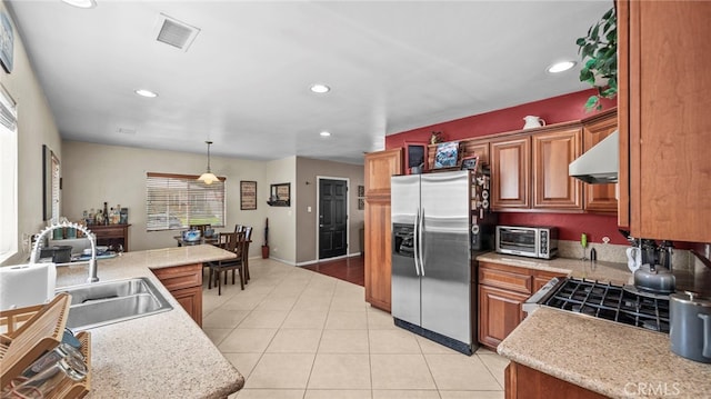 6048 Fidler Ave, Lakewood, CA 90712 - kitchen featuring stainless steel fridge with ice dispenser, under cabinet range hood, light countertops, a sink, and brown cabinets