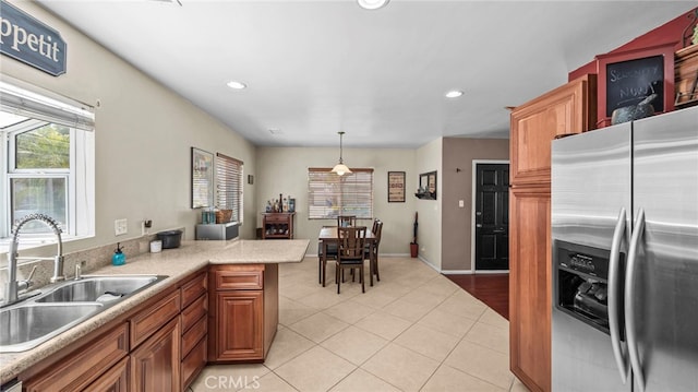 6048 Fidler Ave, Lakewood, CA 90712 - kitchen featuring stainless steel refrigerator with ice dispenser, a sink, light countertops, light tile patterned flooring, and recessed lighting