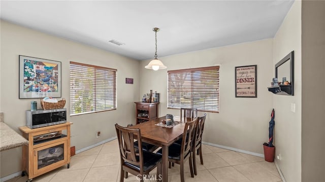 6048 Fidler Ave, Lakewood, CA 90712 - dining area featuring light tile patterned flooring and baseboards
