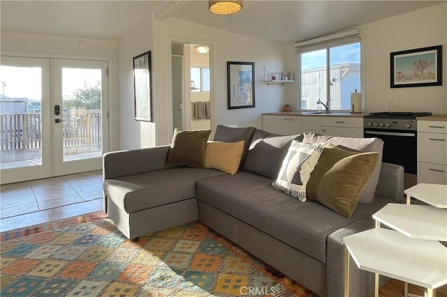 living room featuring french doors and lofted ceiling
