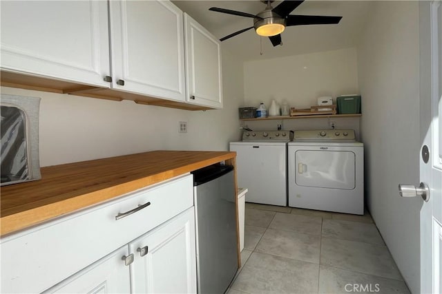 clothes washing area with a ceiling fan, laundry area, washing machine and dryer, and light tile patterned floors