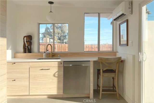 kitchen with an AC wall unit, a wealth of natural light, a sink, and dishwasher