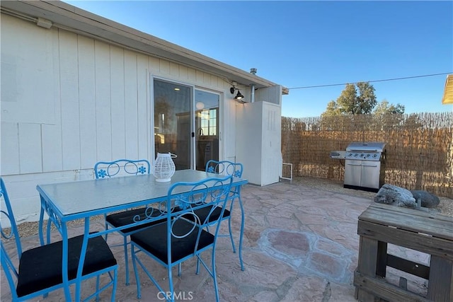 view of patio / terrace featuring fence, outdoor dining area, and grilling area