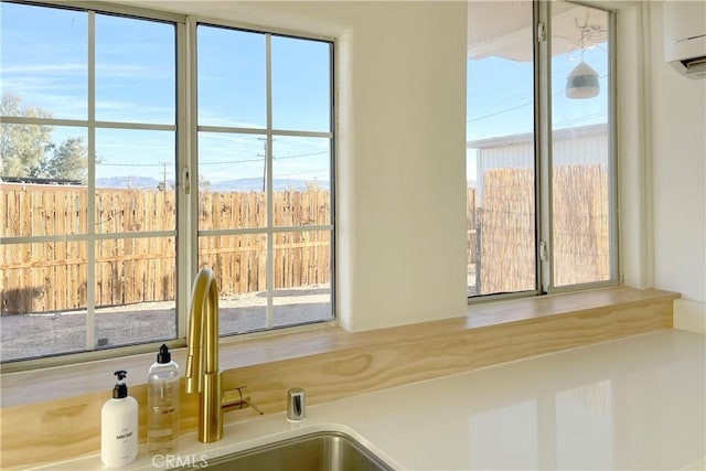 interior details featuring a sink, a mountain view, and a wall mounted air conditioner