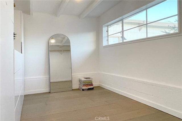 interior space featuring wood finished floors and beamed ceiling