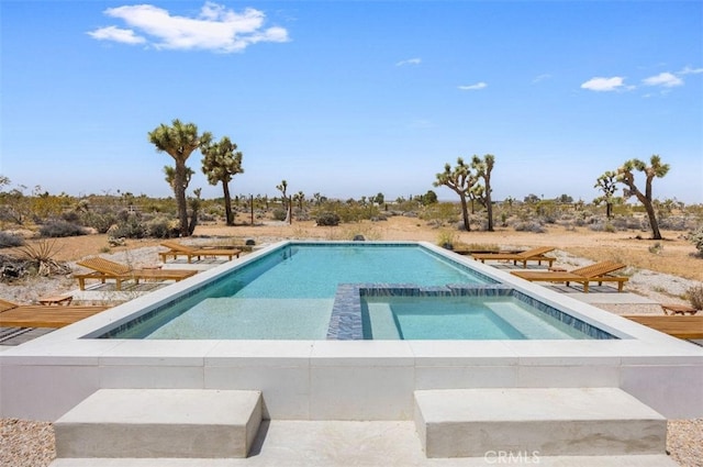 view of pool with a pool with connected hot tub