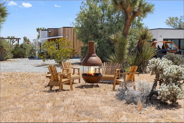 view of yard with a fire pit