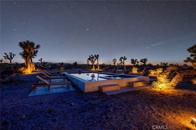 view of pool at dusk