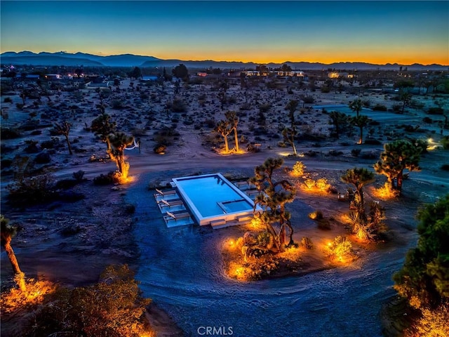 birds eye view of property with a desert view and a mountain view