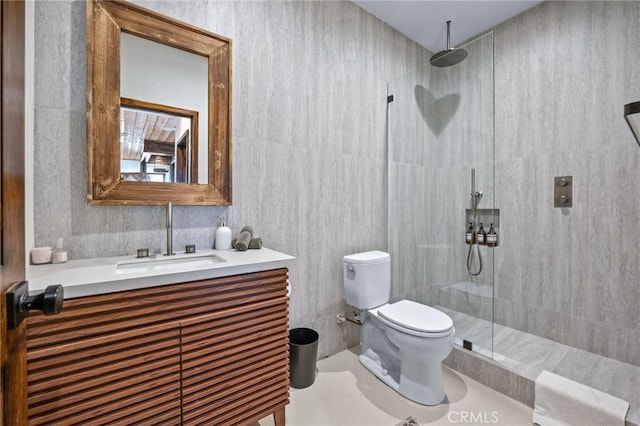 bathroom with vanity, a walk in shower, and toilet