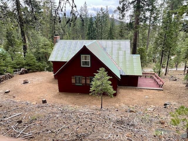 38784 Aspen Ln, Mineral, CA 96063 - view of property exterior featuring metal roof, a chimney, and a wooded view