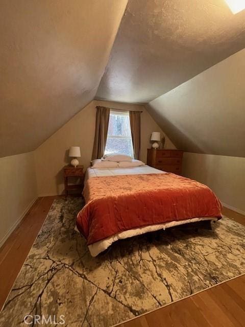 38784 Aspen Ln, Mineral, CA 96063 - bedroom featuring wood finished floors, vaulted ceiling, and baseboards