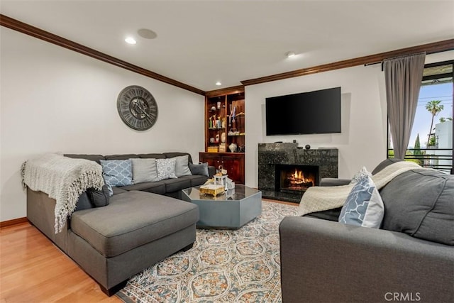450 N Oakhurst Dr Unit 304, Beverly Hills, CA 90210 - living room with crown molding, wood finished floors, a premium fireplace, recessed lighting, and built in shelves
