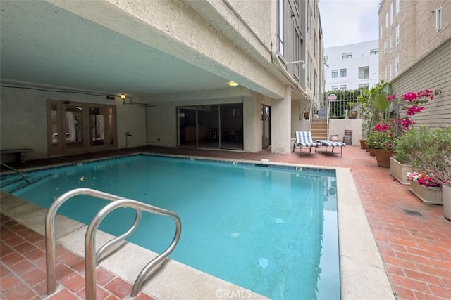 450 N Oakhurst Dr Unit 304, Beverly Hills, CA 90210 - community pool with a patio area and french doors