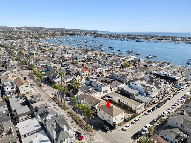 drone / aerial view with a residential view and a water view