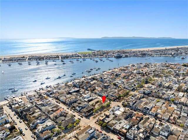 drone / aerial view featuring a water view and a residential view