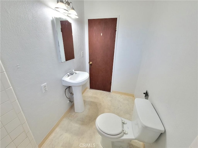 904 Toomes Ave, Corning, CA 96021 - bathroom featuring toilet and baseboards