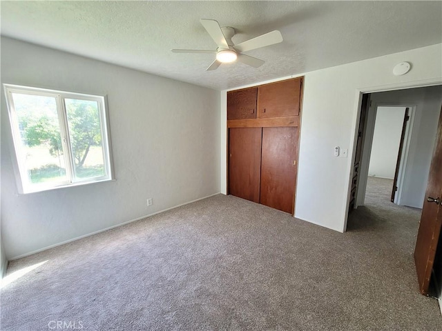 904 Toomes Ave, Corning, CA 96021 - unfurnished bedroom with carpet, a closet, ceiling fan, and a textured ceiling